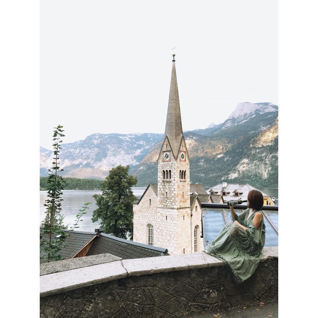 Blue lake hidden between mountains, beautiful decorated houses rising from stoneIt’s somewhat far from&hellip;