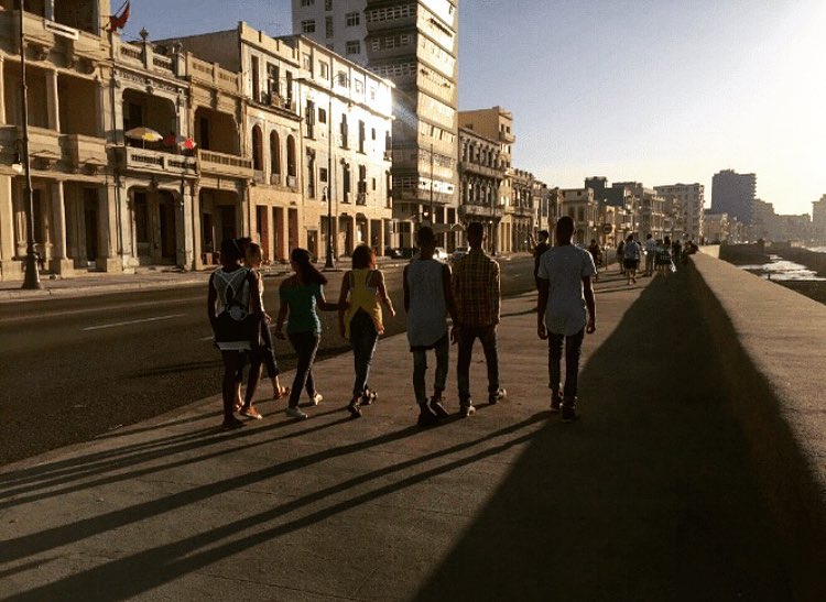 Strolling the Malecon at sunset. Read about our travels to Havana at . .…