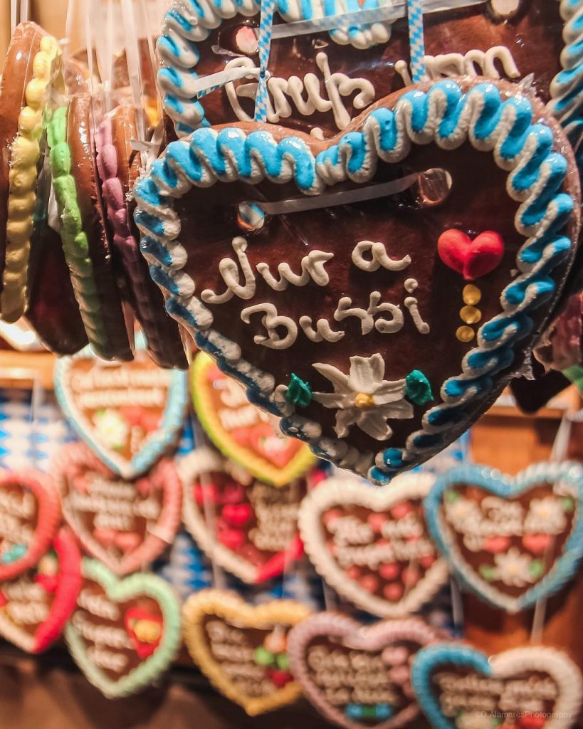 Lebkuchenherz (“gingerbread heart”), a customary accessory for women who wear traditional dirndl dresses to…