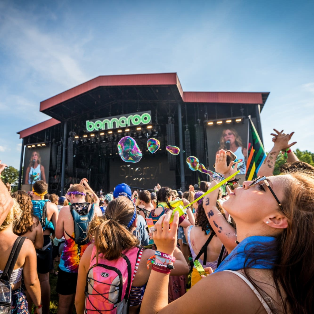 A vibrant festival scene at Bonnaroo 2024, showcasing music, art, and a lively crowd enjoying the atmosphere.
