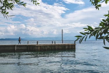 A lonesome lady walks the jetty. While she was making photos of lake…