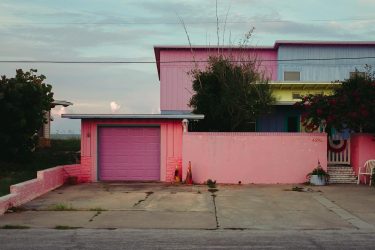 by the ocean a houses colors so vividly pleasing to the eyes. . .…