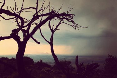 Watching a storm sweep across the valley below while I camp on cliff edge…