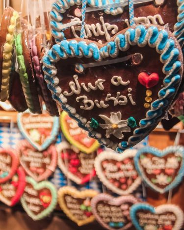 Lebkuchenherz (“gingerbread heart”), a customary accessory for women who wear traditional dirndl dresses to…