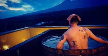 Relaxing at a private root top spring after a long hiking day