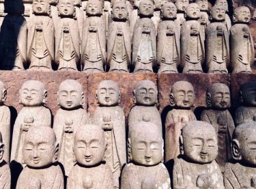 Welcome to Hase-dera, a site of somber beauty which contains dozens of small Jizo…