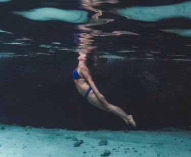 She would be half a planet away, floating in a turquoise sea, dancing by…