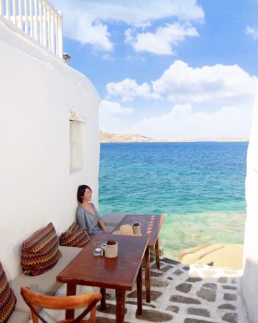 Kastro’s Bar with island furnishings and a small balcony overlooking the sea, the bar…