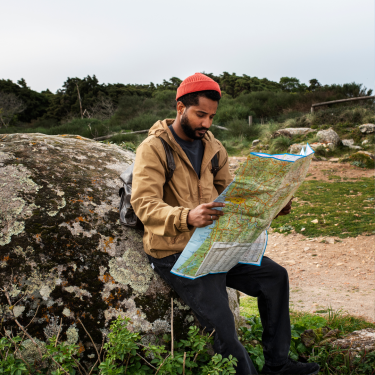 A traveler exploring a remote destination, promoting sustainable tourism and reducing carbon footprints in developing countries.