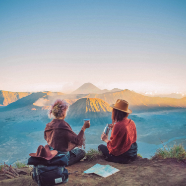 Travelers engaging with local culture in a bustling city, highlighting the educational benefits of travel.