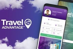 Image of Travel Advantage and bnesim partnership banner, set against a purple sky with a mobile phone in the foreground.
